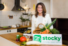 Ministerin in einer Küche mit Gemüsekorb und Stocky-Logo
