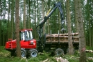 Forstspezialmaschine mit Greifarm und Metallkorb zum Holztransport